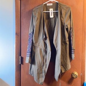 Olive color jacket with detail on sleeve